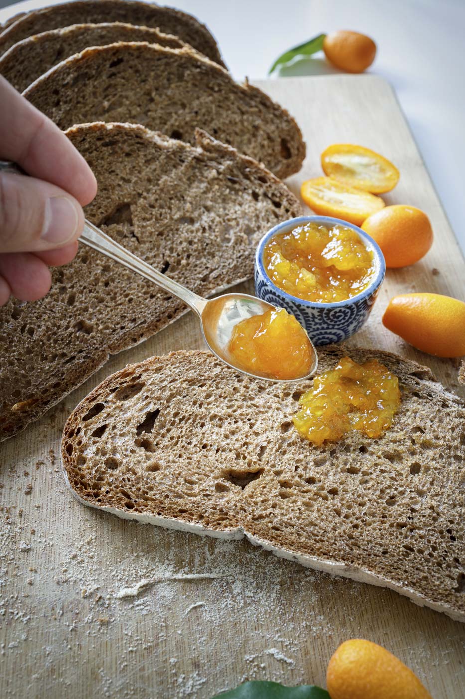 Lazaris private tour tasting corfu hand serving orange jam with spoon slice bread kumquat jam
